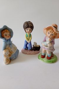 vintage small children with animals pottery figurines set